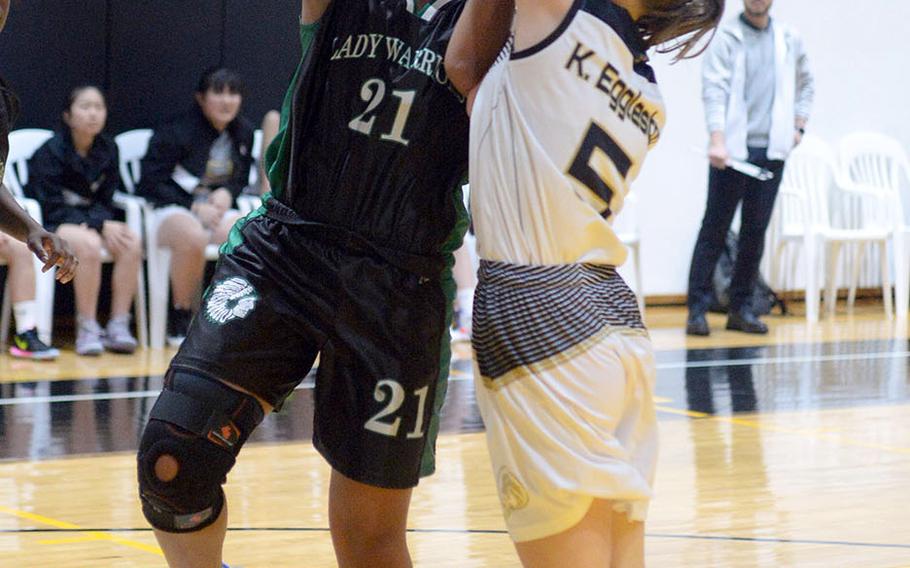 Daegu's Katrina Vasquez tries to shoot over Taejon Christian's Katie Eggleston during Friday's Korea Blue girls basketball game. The Warriors won 54-22.