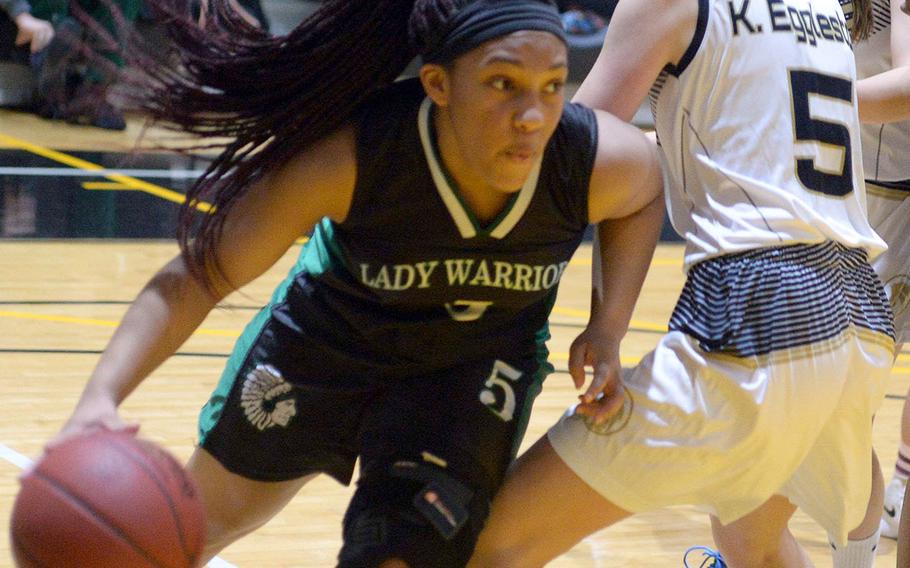 Daegu's Bethani Newbold dribbles around Taejon Christian's Katie Eggleston during Friday's Korea Blue girls basketball game. The Warriors won 54-22.