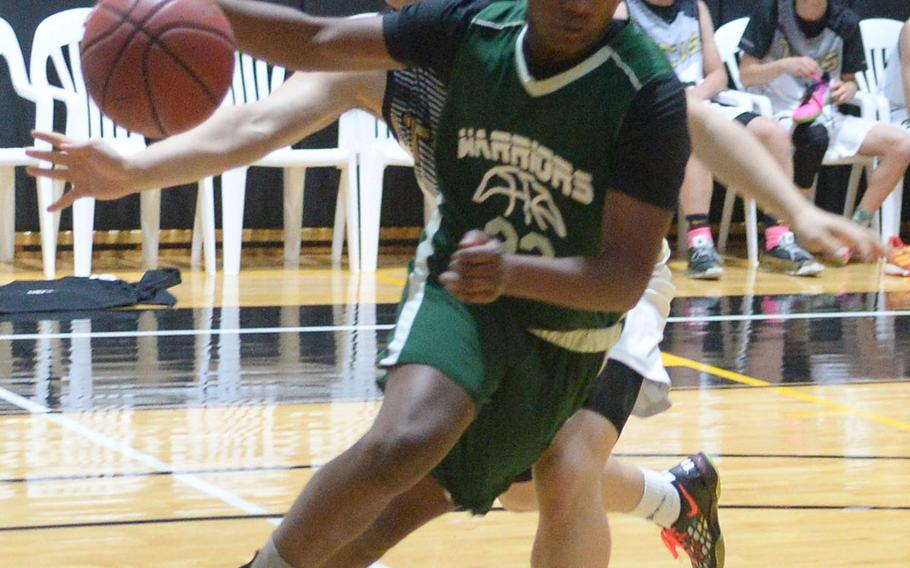Daegu's Antwoine McCall dribbles past Taejon Christian's Lorens Kim during Friday's Korea Blue boys basketball game. The Dragons won 47-26.