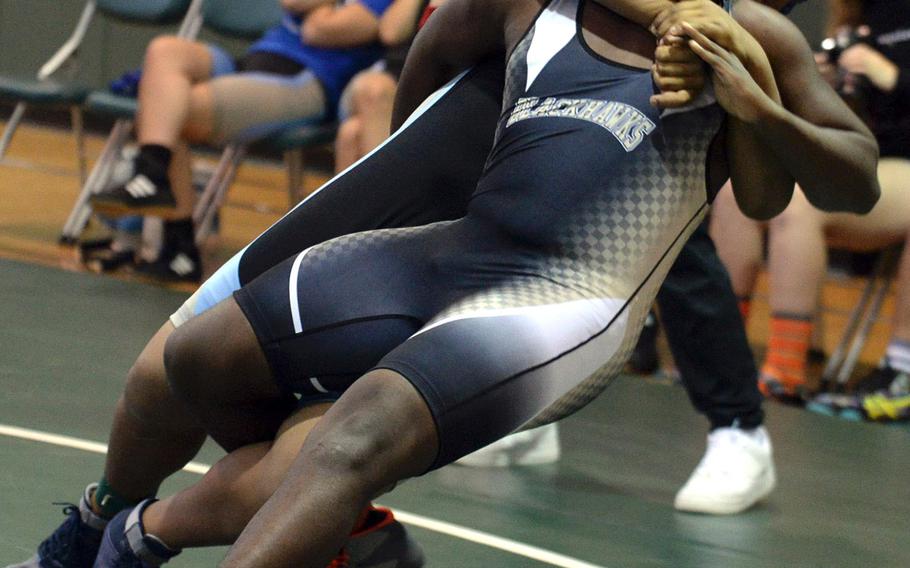 Osan's Myles Bradley, back, tilts Humphreys' Dontrell Powers at heavyweight during Saturday's Daegu quad meet. Bradley won by pin in 1 minute, 9 seconds.