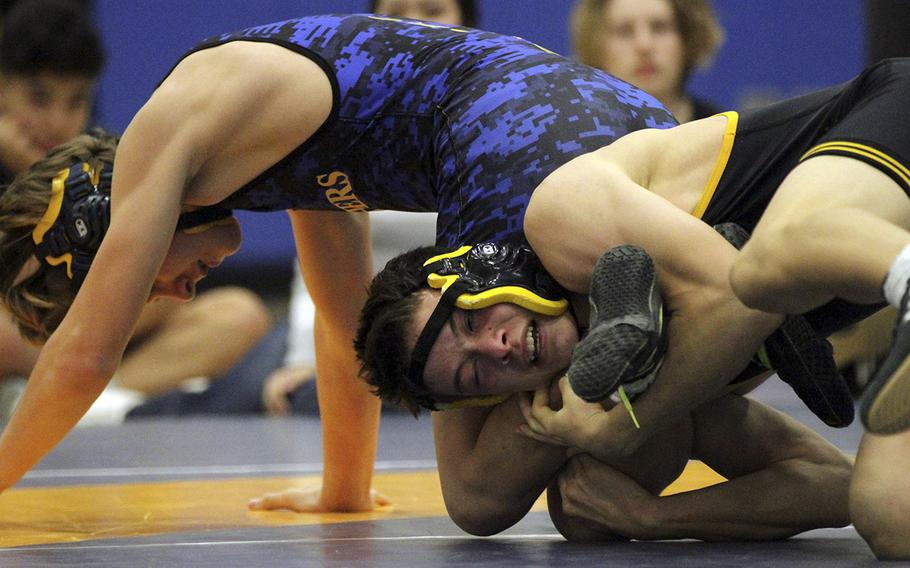 American School In Japan's Kai Hortman leg laces Yokota's Caleb Jones en route to winning the 135-pound title during Saturday's Yokota Invitational.