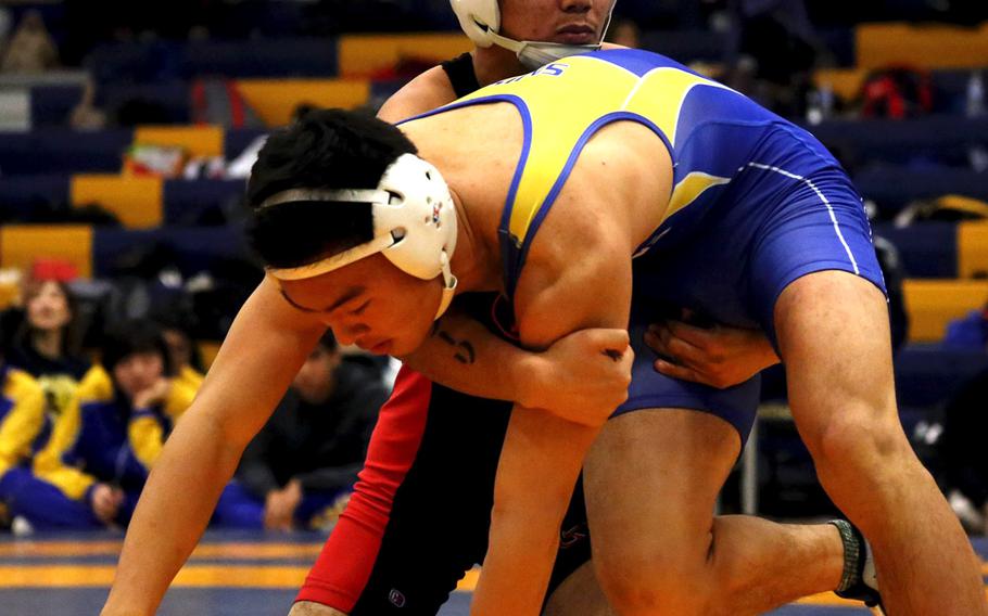 St. Mary's International's Hikaru Shimada, front, and Nile C. Kinnick's Josiah Millare tangle at 141 pounds during Saturday's Yokota Invitational. Shimada would go on to win the title.