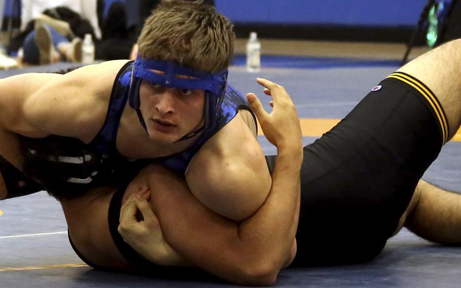 Yokota's Austin Fisher pins Dani Rahman of American School In Japan to win the 215-pound title during Saturday's Yokota Invitational.