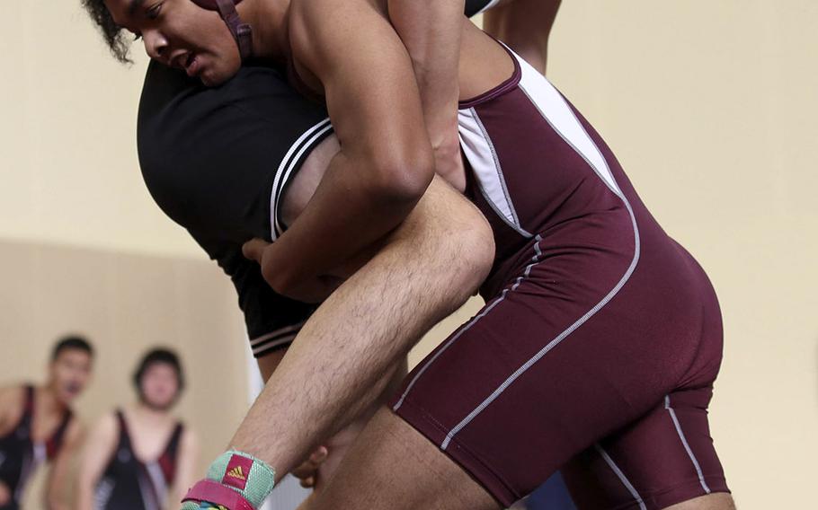Matthew C. Perry's Keon Cassell works a 9-7 decision over Zama's Milton Jones at 168 pounds during Saturday's Perry Invitational.