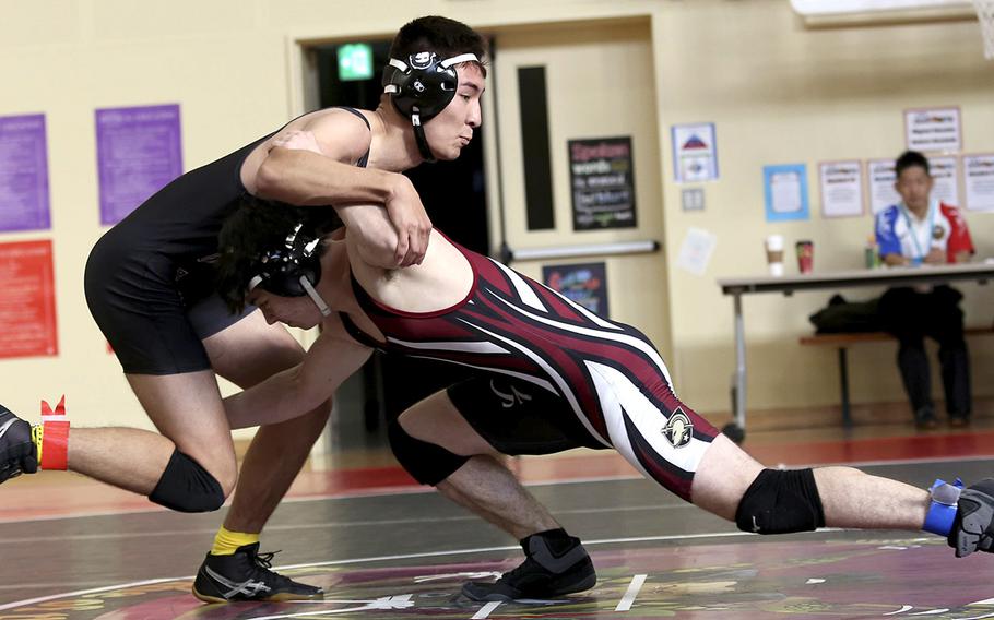 Zama's Eligh Cabe, left, pinned Matthew C. Perry's Matthew Adams twice, but the Samurai won two dual meets against the Trojans during Saturday's Perry Invitational.