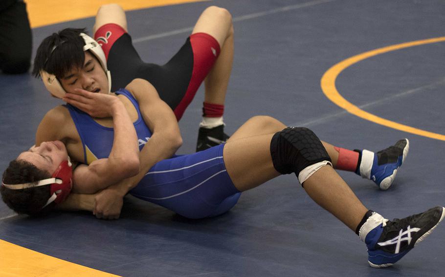 St. Mary's International's Isaac Shane gets Nile C. Kinnick's D.J. Hurtado in a head-and-arm hold en route to winning the 101-pound title in Saturday's Yokota Invitational.