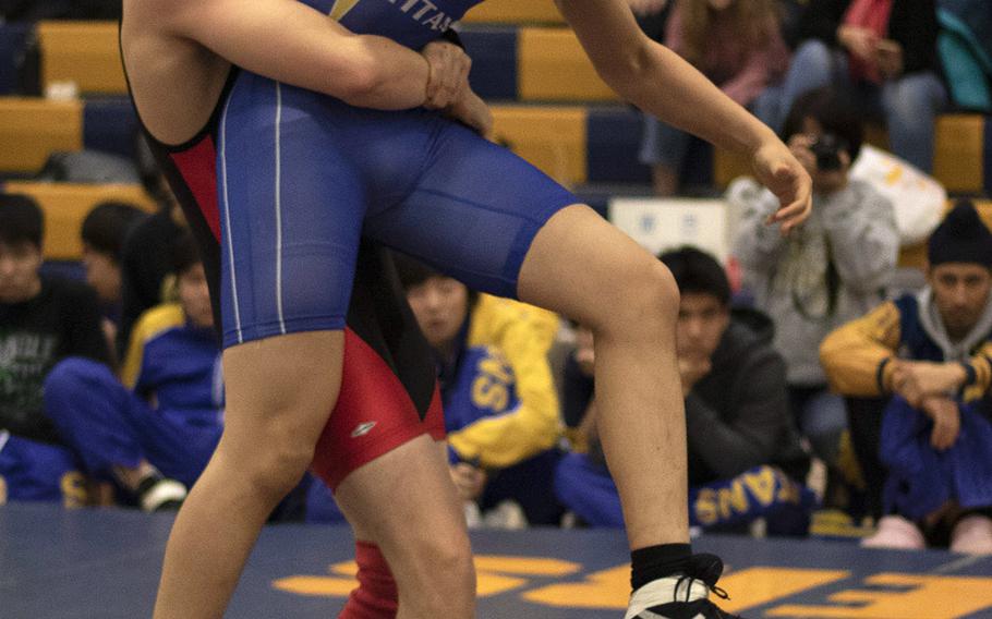 Nile C. Kinnick's Alex Lovell lifts St. Mary's Lev Titov en route to winning the 168-pound title in Saturday's Yokota Invitational.