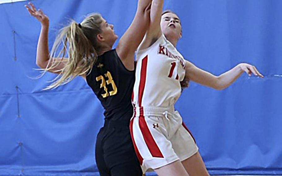 American School In Japan's Christiana Regent and Nile C. Kinnick's Cassi Boyer sky for the ball during Saturday's Kanto Plain girls basketball game. The Mustangs won 18-16.