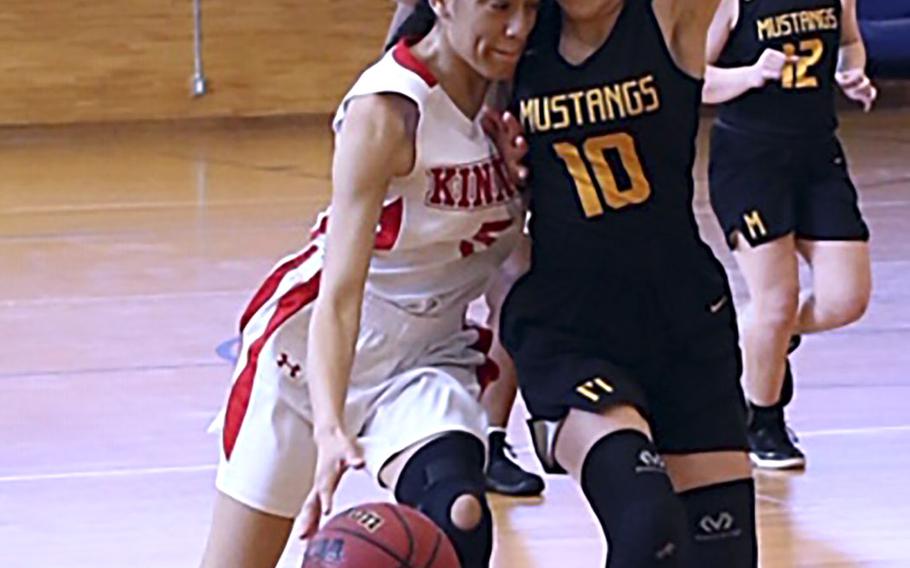 Nile C. Kinnick's Ernestina Roberts dribbles against American School In Japan's Cora Eaton during Saturday's Kanto Plain girls basketball game. The Mustangs won 18-16.