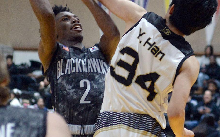 Humphreys' Myles Johnson puts up a shot against Taejon Christian International's Yisoo Han during Wednesday's Korea Blue boys basketball game. The Blackhawks won 78-30.