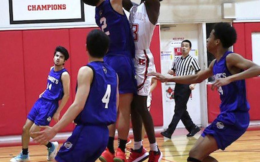 Nile C. Kinnick's Corey Hollingsworth shoots against St. Mary's Aidan O'Flaherty during Tuesday's Kanto Plain boys basketball game. The Titans won 74-54.