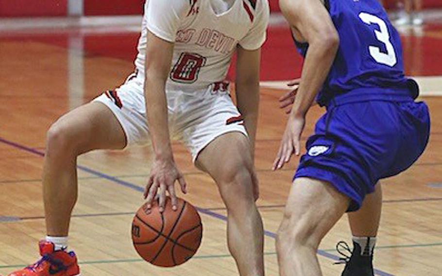 Nile C. Kinnick's Tristan Venturina dribbles against St. Mary's Jei Arai during Tuesday's Kanto Plain boys basketball game. The Titans won 74-54.