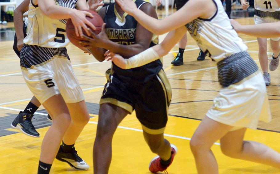 Humphreys' Acacia May gets tied up by Taejon Christian's Katie Eggleston and Haneul Jang during Wednesday's Korea Blue girls basketball game. The Blackhawks won 44-17.