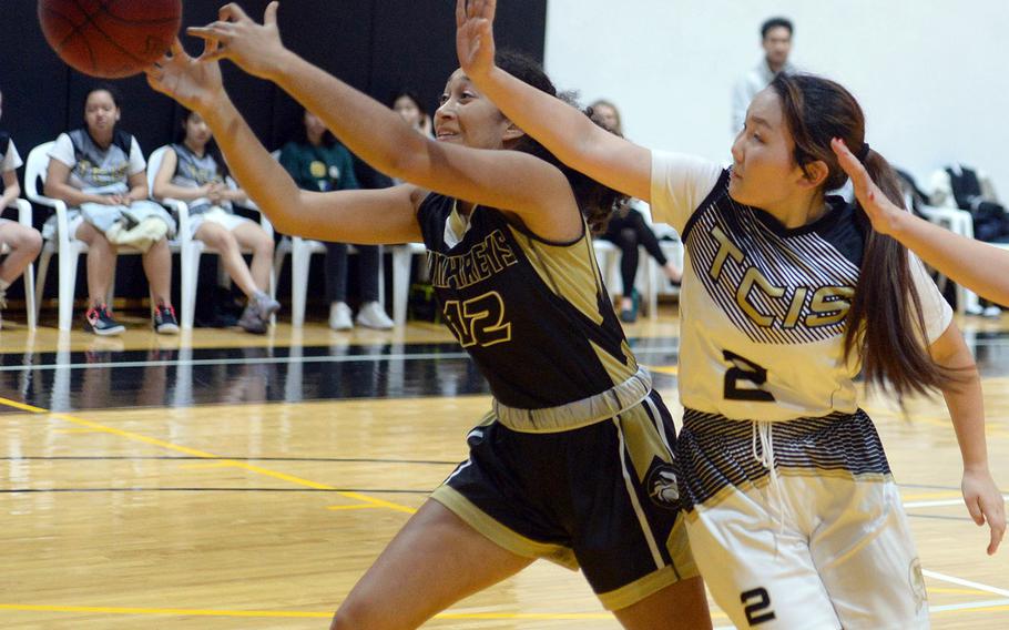 Humphreys' Melissa Pritchett can't quite find the handle on the ball in front of Taejon Christian's Minha Choi during Wednesday's Korea Blue girls basketball game. The Blackhawks won 44-17.