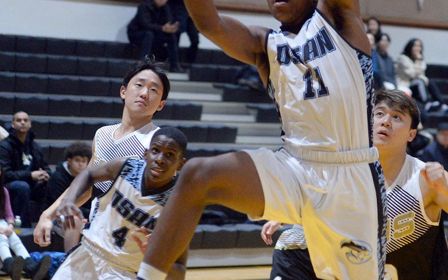 Osan's Bryson Goldsmith drives for a shot against Taejon Christian during Tuesday's Korea Blue boys basketball game. The Cougars won 58-53, their second straight win, both against TCIS.