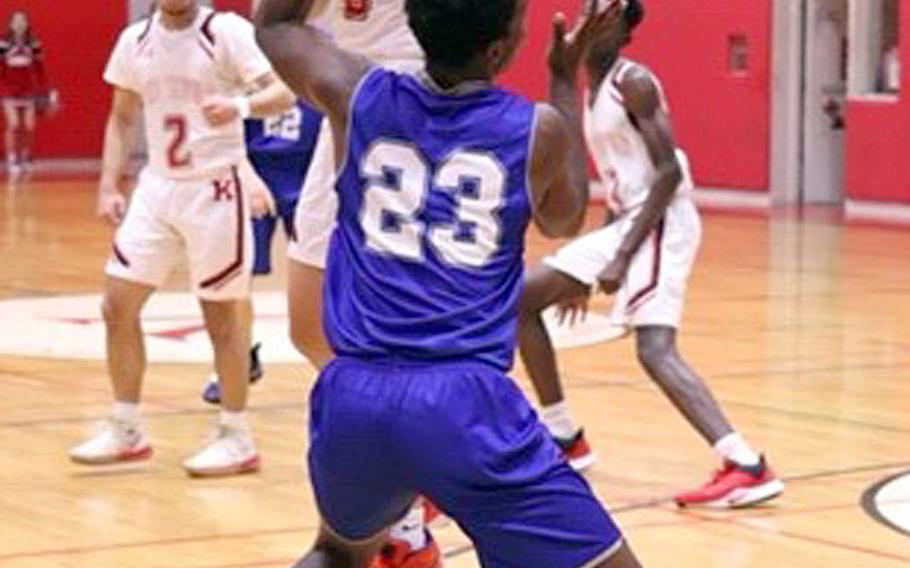 Nile C. Kinnick's Tristan Venturina tries to maintain control against Christian Academy Japan's Enosh Mutenda during Friday's Kanto Plain boys basketball game. The Knights won 68-64.