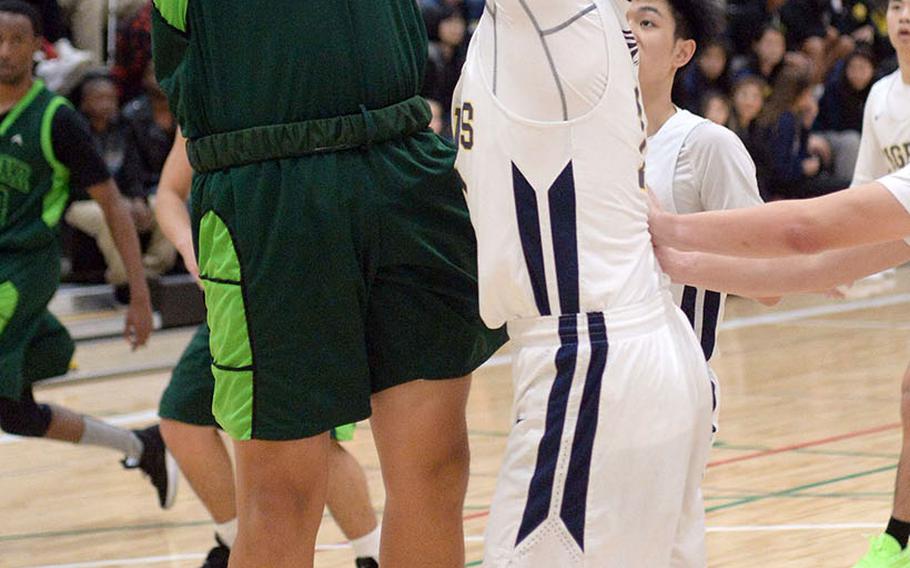 Kubasaki's Sebastian Stone shoots against Taipei American during Saturday's Taipei Basketball Exchange boys game. The Dragons rallied to win 63-58.