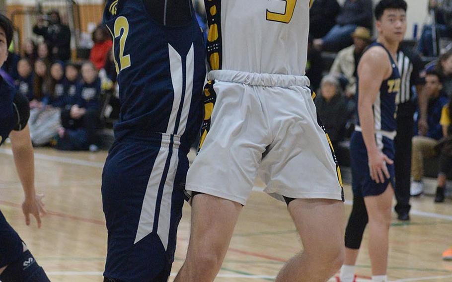Kadena's Blake Dearborn goes up for a shot against Taipei American during Saturday's Taipei Basketball Exchange boys game. The Panthers won 86-79 in double overtime.