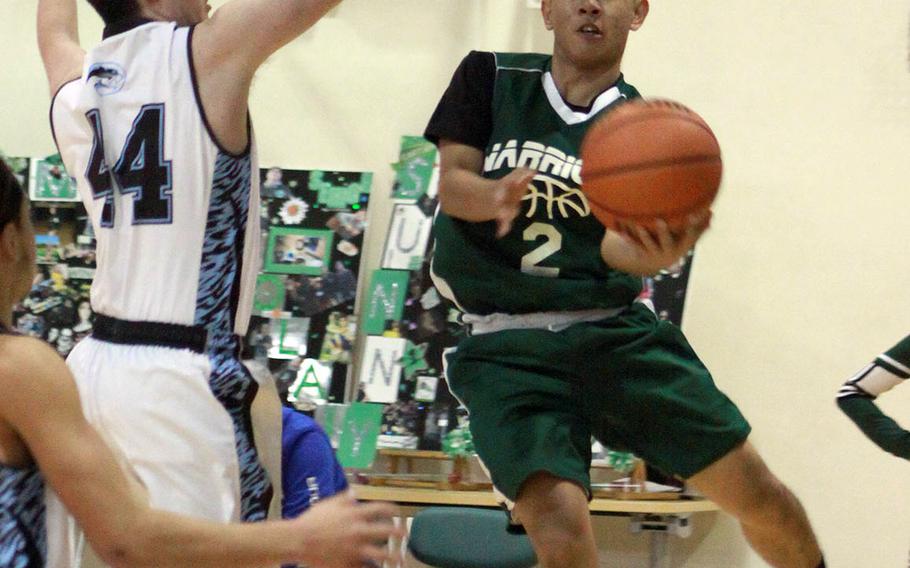 Daegu's Kyle Obien drives against Osan's Jack Cornelius during Saturday's Korea Blue boys basketball game. The Cougars won 56-31.