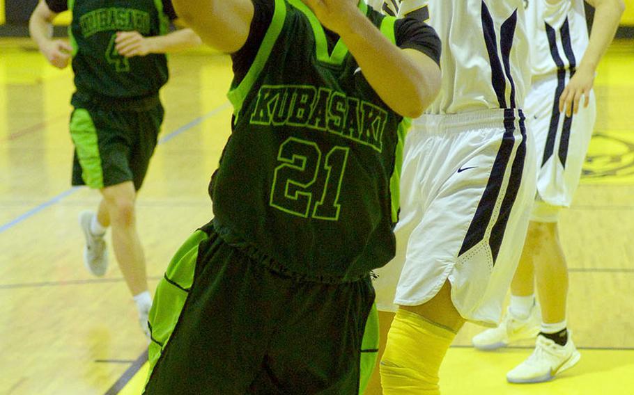Kubasaki's Dylan Canlas drives for a shot against Taipei American during Sunday's Taipei Basketball Exchange boys game. The Tigers won 72-58; the Dragons split their two games with the Tigers.