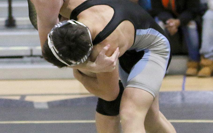 Osann's Toy Williams lifts Humphreys' Zack Downs en route to a pinfall victory in 1 minute, 41 seconds at 141 pounds during Saturday's dual meet at Humphreys. The Blackhawks won the meet 42-19.