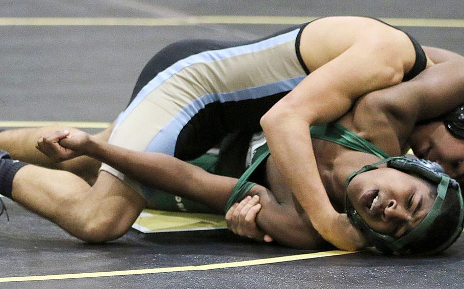 Osan's Zathian Soto scores a pin at 129 pounds over Daegu's Jayvon Pryor. The Cougars won Saturday's dual meet with the Warriors 38-0.
