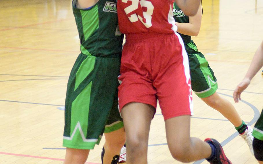 Nile C. Kinnick's Dana White tries to shoot over Kubasaki's Gracie Leishman during Thursday's ASIJ Kanto Classic girls game. The Red Devils won 31-24.