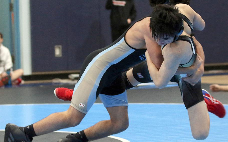 Osan's Zathian Soto brings Humphreys' Christian Ji to the mat at 129 pounds en route to a pinfall victory in 1 minute, 12 seconds.