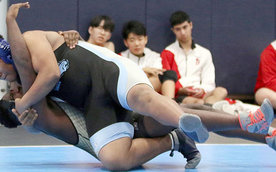 Osan's heavyweight Myles Bradley wrestles Humphreys' Dontrell Powers to the mat en route to a win by pin in 43 seconds.