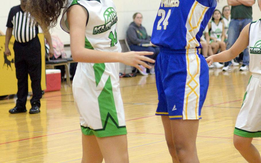 Yokota's Jaya Walker tries to shoot through the block of Kubasaki's Sophia Grubbs during Friday's ASIJ Kanto Classic girls game. The Panthers won 34-27.