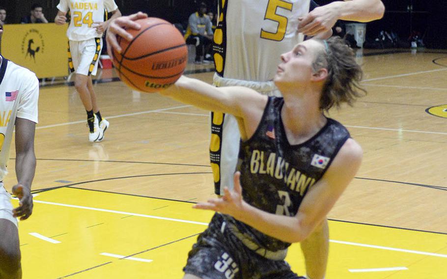 Humphreys' Connor Coyne looks to move past Kadena's Blake Dearborn during Friday's ASIJ Kanto Classic boys game. In what many observers called a possible championship-game preview, the defending champion Blackhawks edged the Panthers 49-46.