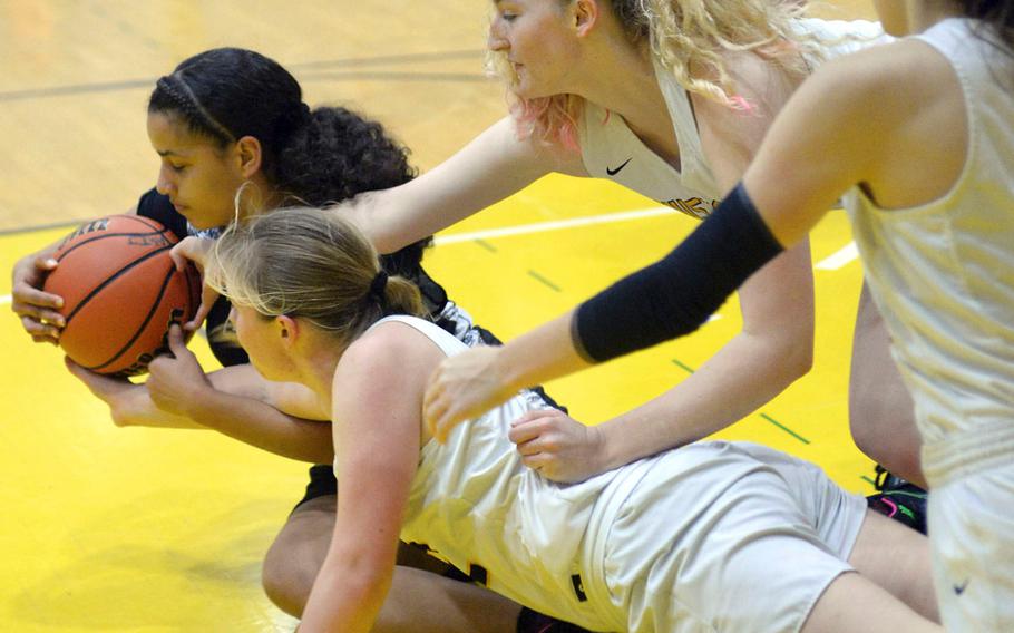 Zama's Fabiola Ayala-Rivera tries to shield the ball from three American School In Japan defenders during Saturday's girls varsity basketball finals game. Zama won the game and the tournament championship.