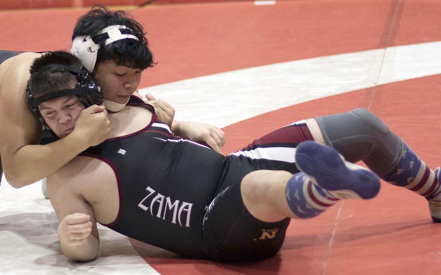 Nile C. Kinnick's Kaleb Leon Guerrero gains the edge on Zama's Josh Petty at 180 pounds during Wednesday's Kanto Plain dual meet. Leon Guerrero won by pin in 2 minutes, 45 seconds and the Red Devils won the meet 47-14.