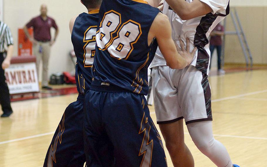 Matthew C. Perry's Tristan Tanjuanquio runs into a wall of Iwakuni Takamizu defenders during Wednesday's Japan boys basketball game. The Samurai won 77-70.