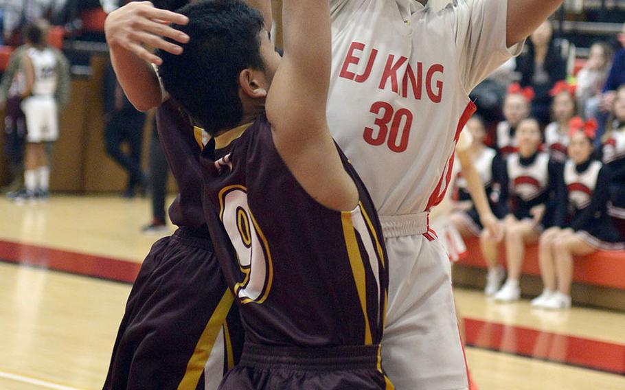 E.J. King's Jalen Nall shoots against two Noda Gakuin defenders during Friday's Japan boys basketball game. The Cobras won 63-22.