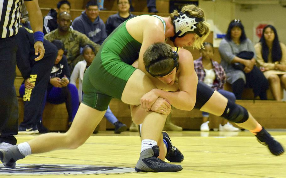 Kubasaki's Andrew Barnes gains the edge on Kadena's Joey Puterbaugh en route to a 12-6 decision at 168 pounds. Kubasaki won the final Okinawa regular season dual meet 43-18.