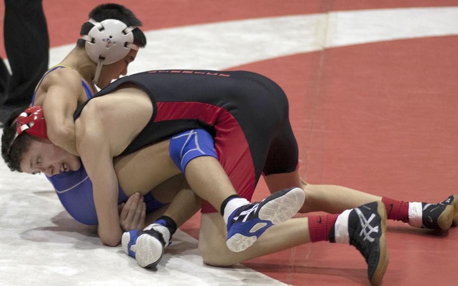 Nile C. Kinnick's D.J. Hurtado takes control of St. Mary's  Isaac Shane at 101 pounds during Wednesday's Kanto Plain wrestling dual meet. Hurtado pinned Shane in 2 minutes, 30 seconds and the Red Devils won 45-14, forging a three-way tie for the regular-season title between Kinnick, St. Mary's and American School In Japan, each with one loss.