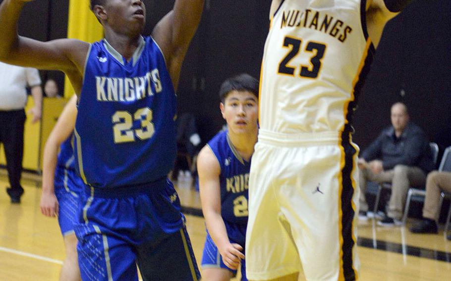 American School In Japan's Adam Knode shoots against Christian Academy Japan's Enosh Mutenda during Wednesday's Kanto Plain boys basketball game. The Mustangs won 49-44,. Knode is a second-generation Mustang; his father, Steve, played for ASIJ in the mid-1980s.