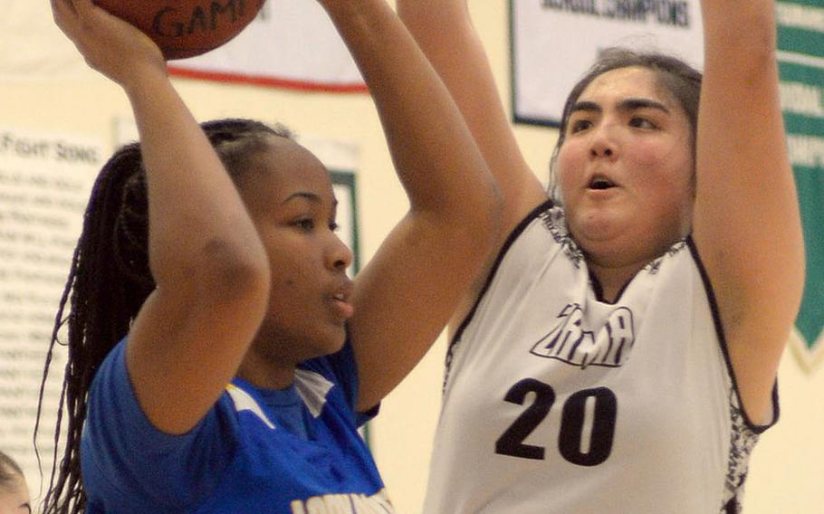 Yokota's Kimaya Morgan tries to pass against Zama's Jessica Atkinson during Friday's DODEA-Japan girls semifinal, won by the Trojans 68-37.