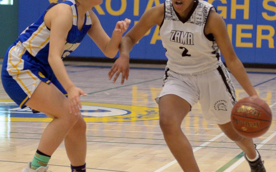 Yokota's Keiya Carlson defends against Zama's Chloe Sterling during Friday's DODEA-Japan girls semifinal, won by the Trojans 68-37.