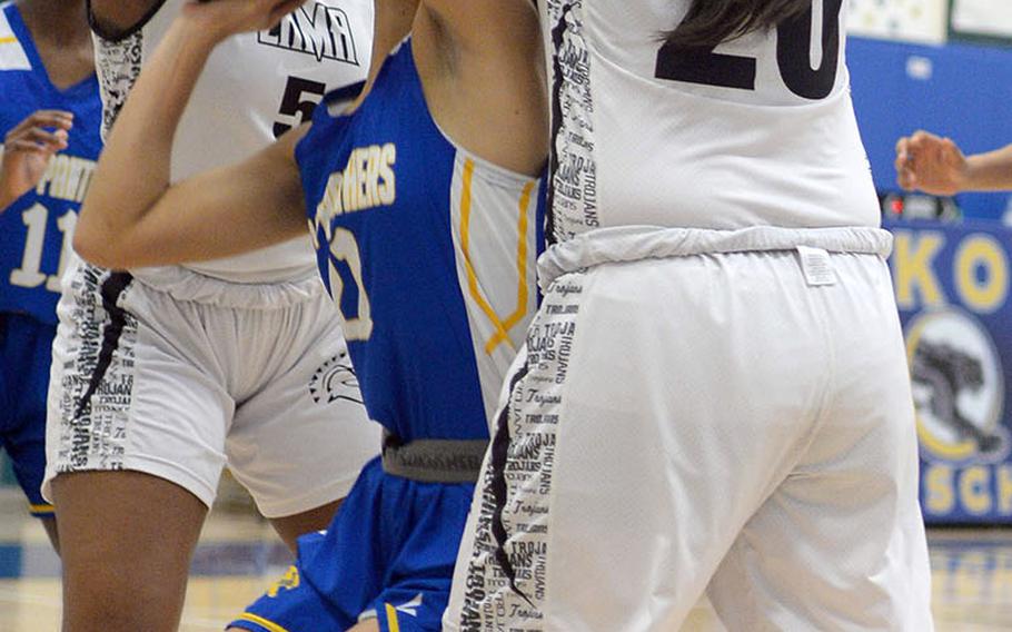 Yokota's Hana Robbins finds herself bottled up by Zama's Jalina Colar and Jessica Atkinson during Friday's DODEA-Japan girls semifinal, won by the Trojans 68-37.