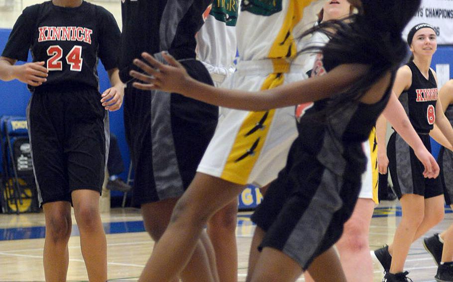 Nile C. Kinnick's Kiana Johnson and Robert D. Edgren's Naomi Andrews cannot find the handle on the ball during Friday's DODEA-Japan girls semifinal, won by the Red Devils 47-18.