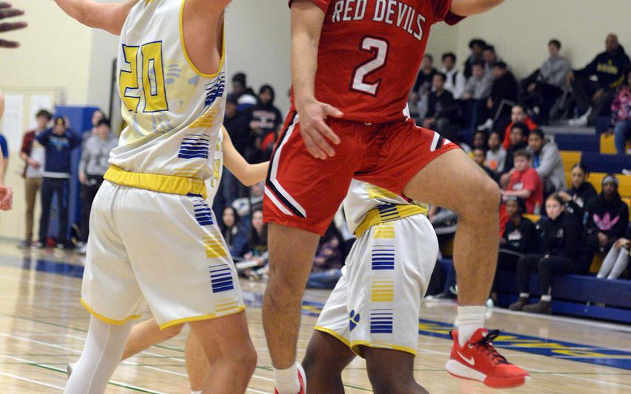 Nile C. Kinnick's James Mincey drives past Yokota's Connor Rowan for a shot during Friday's DODEA-Japan boys semifinal, won by the Red Devils 68-64.