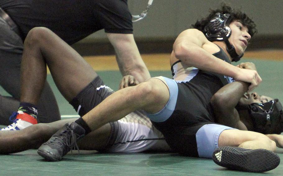 Osan's Zathian Soto finishes off Humphreys' DeShawn Adkins for a pinfall victory at 129 pounds during Saturday's Korea wrestling tri-meet at Daegu. The Cougars beat the Blackhawks 31-21.