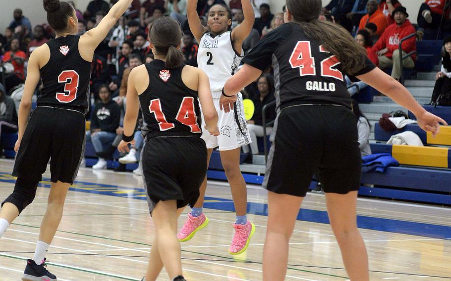 Zama's Chloe Sterling shoots over Nile C. Kinnick's Ernestina Roberts, Olivia Ouellette and Madelyn Gallo.