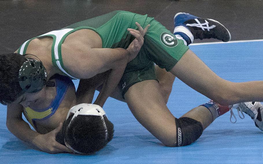 Kubasaki's Nicholaz Aguirre twists the shoulders of St. Mary's Isaac Shane toward the mat in the 101-pound Far East final. Aguirre won by technical fall 15-5.