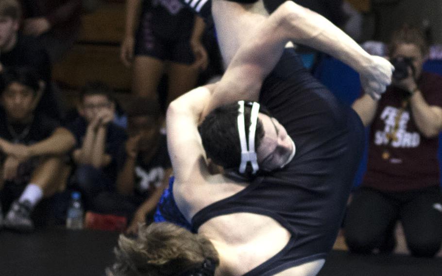 Yokota's Owen Taylor sends Perry's Parker Staley airborne en route to a 17-7 technical-fall victory at 141 pounds.