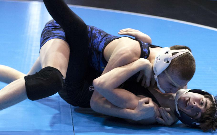 Yokota's Caleb Heino pins Perry's Marcus Irons in 4 minutes, 22 seconds at 122 pounds.