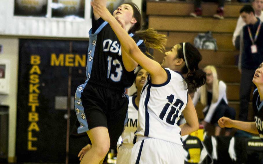 Osan's Kennedy Liddell shoots past two Sacred Heart defenders during the Symbas' 39-6 win over the Cougars.
