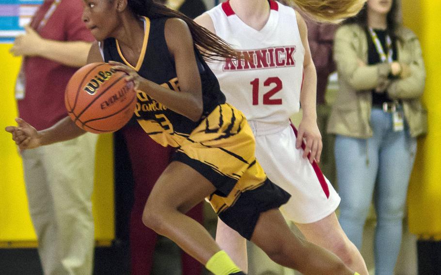 Kadena's Christee Dervil dribbles past Kinnick's Paige Drumm during the Panthers 49-37 win.